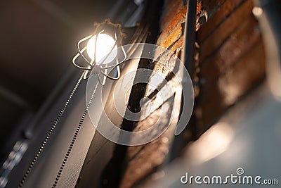 Antique electronic lamp, red wall lamp, high wall lamp, soft light.Red brick wall.Open chain, turn off the lights.hanging at the r Stock Photo