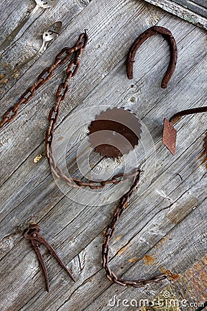 Antique farm tools hanging on a wall Stock Photo