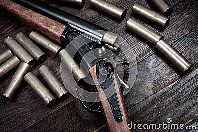 Antique 12-gauge break-action smooth-bored shotgun with yellow brass cases Stock Photo