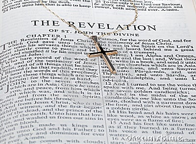 Antique gold cross on page of bible Stock Photo