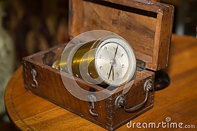 Antique Golden Compass inside Wooden Box on a Table Stock Photo