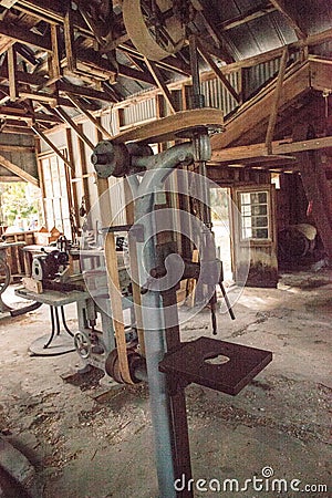 Antique H.G. Barr Drill Press inside the 1904 Large Machine Shop at historic Koreshan State Park Editorial Stock Photo
