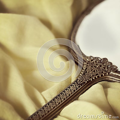 Antique Hand Mirror over Soft Fabric Stock Photo