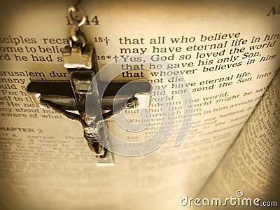 Antique handmade Rosary Crucific Hangs over Bible Verse from Heaven`s View Stock Photo