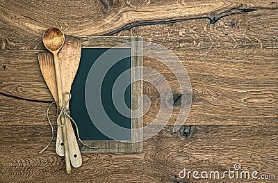 Antique kitchen utensils and blackboard on wooden background Stock Photo
