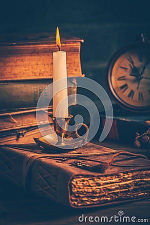 Antique leather-bound journal, book or diary with old books and candle Stock Photo