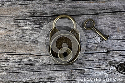 Antique lock with key on vintage wooden planks in close up layout Stock Photo