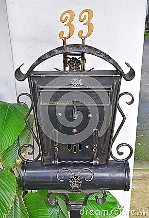 Antique looking rustic outdoor standalone letter box Stock Photo