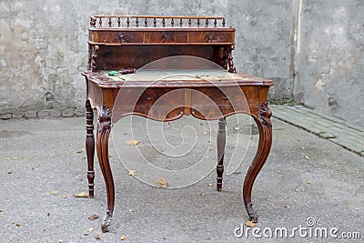 Antique mahogany writing desk with ornate carving Stock Photo