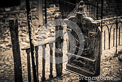 An antique mail box with an embossed figurine of a messenger pigeon, covered with spider webs. Translation of `mail` in Stock Photo