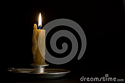 Antique metal candlestick with burning candle Stock Photo