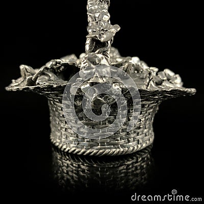 Antique metal figurine in the form of a basket with flowers Stock Photo