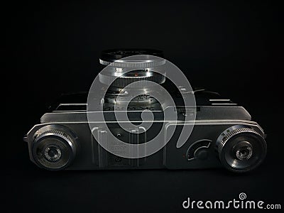 Antique obsolete russian or soviet professional dslr camera with film from ussr, retro photography equipment in darkness against Editorial Stock Photo