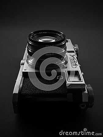 Antique obsolete russian or soviet professional dslr camera with film from ussr, silhouette of retro photography equipment against Editorial Stock Photo