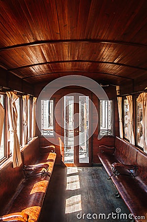 Old classic train wooden interior with curtain and afternoon light Editorial Stock Photo