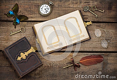 Antique photo album with butterfly over wooden background Stock Photo