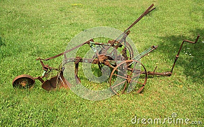 Antique plow at a farm in the summer field Stock Photo