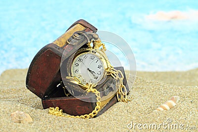 Antique pocket clock in a treasure chest Stock Photo