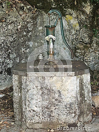 Antique pump for pumping out spring water Stock Photo