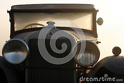 An antique racecar with a faded blackandwhite livery and a shining chrome grill. Speed drive concept. AI generation Stock Photo