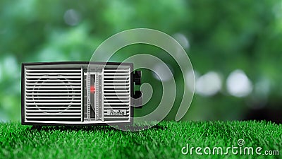 Antique radio transistor on green grass Stock Photo