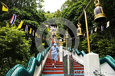 Antique red stairs of Chinese Dragon Tunnel to Ku Ha Mangkorn Sawan or Bua Kli Cave of Wat Ban Tham temple for thai people travel Editorial Stock Photo