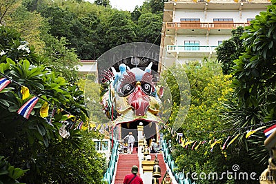 Antique red stairs of Chinese Dragon Tunnel to Ku Ha Mangkorn Sawan or Bua Kli Cave of Wat Ban Tham temple for thai people travel Editorial Stock Photo