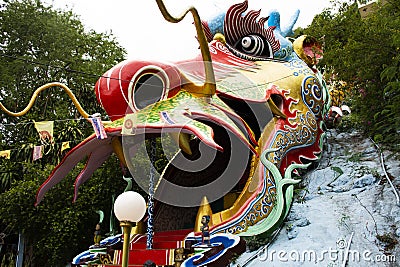 Antique red stairs of Chinese Dragon Tunnel to Ku Ha Mangkorn Sawan or Bua Kli Cave of Wat Ban Tham temple for thai people travel Editorial Stock Photo