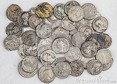 Antique Roman coins, a small pile of cash on a white background Stock Photo