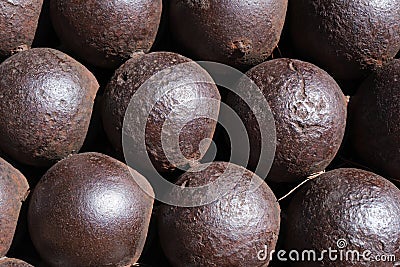 Antique rusty cannon balls, pattern, closeup, ancient iron cannonball. Stock Photo