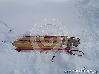Antique sled stuck in snow Stock Photo