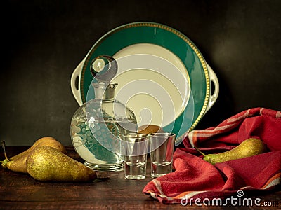 Antique-style still life with pears and alcohol. Stock Photo