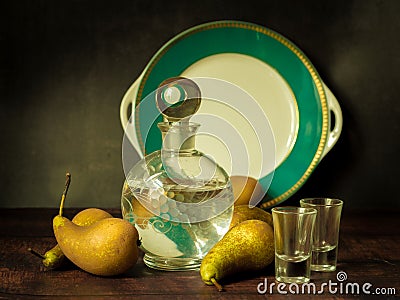 Antique-style still life with pears and alcohol. Stock Photo