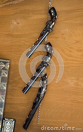 Antique stylistic revolve-like gun on wooden background Stock Photo