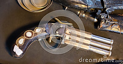 Antique stylistic revolve-like gun on wooden background Stock Photo