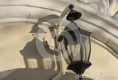 Antique stylized lantern giving a beautiful shade with a broken light bulb inside Stock Photo