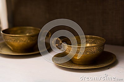 Antique tea mugs with copper saucers. Unusual home decor items Stock Photo