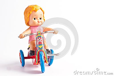 antique tin toy girl ride bicycle Stock Photo