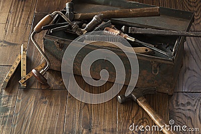 Antique tools and toolbox on dark wood surface Stock Photo