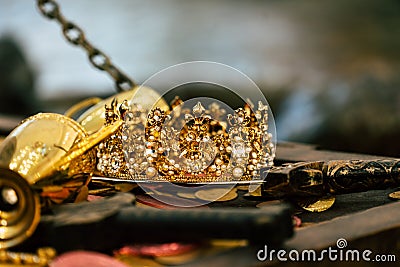 Antique treasure gold crown with coins for wealth , luxury and success concept Stock Photo