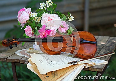 Antique violin, notes and spring bouquet Stock Photo