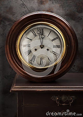 Antique wall clocks on a vintage table Stock Photo