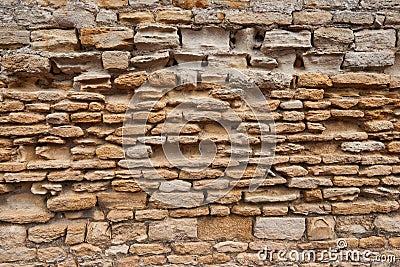 Antique wall with unevenly arranged old bricks Stock Photo