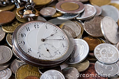 Antique watch and coins Stock Photo