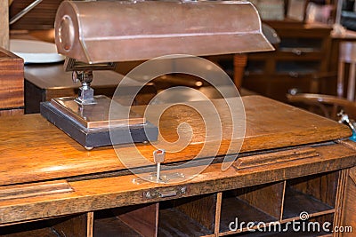 Antique wooden writing desk with lamp, key lock and compartments Stock Photo