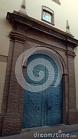 An antique wrought iron door to a church Stock Photo