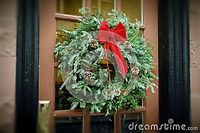 Antiqued Christmas Wreath hanging on door Stock Photo