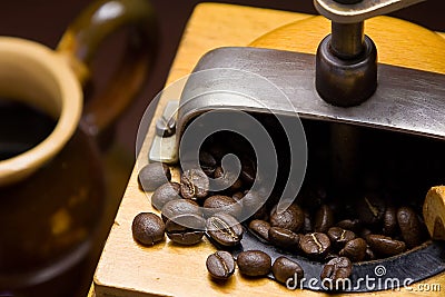 Antiquity coffee grinder and cup of cofe Stock Photo