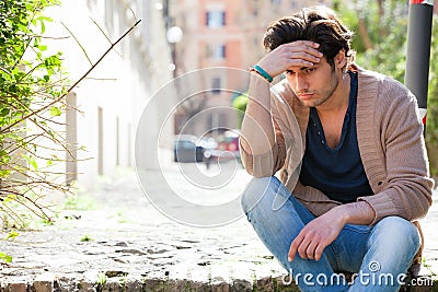 Anxiety. Thoughtful young man anxious, outdoors Stock Photo