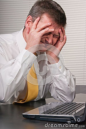 Anxious business man holds head Stock Photo